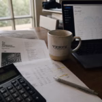 Tax documents and financial planning spreadsheet on a desk with natural side lighting